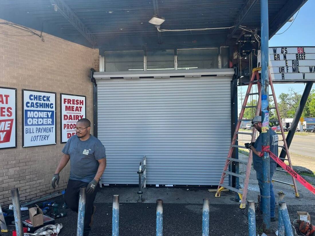 We Fix Garage Doors crew installing a commercial roll-up door at a storefront