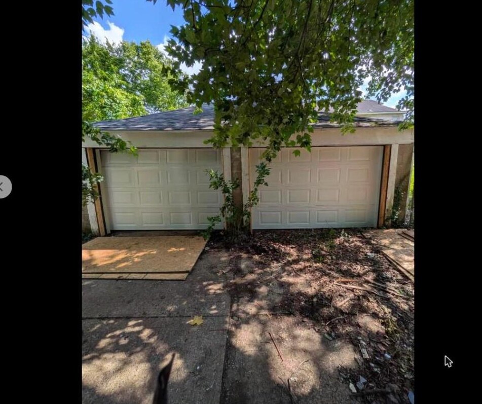 Two clean new white garage doors after installation