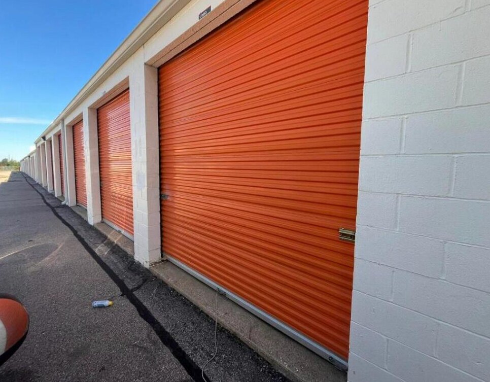 Row of commercial roll-up storage facility doors serviced