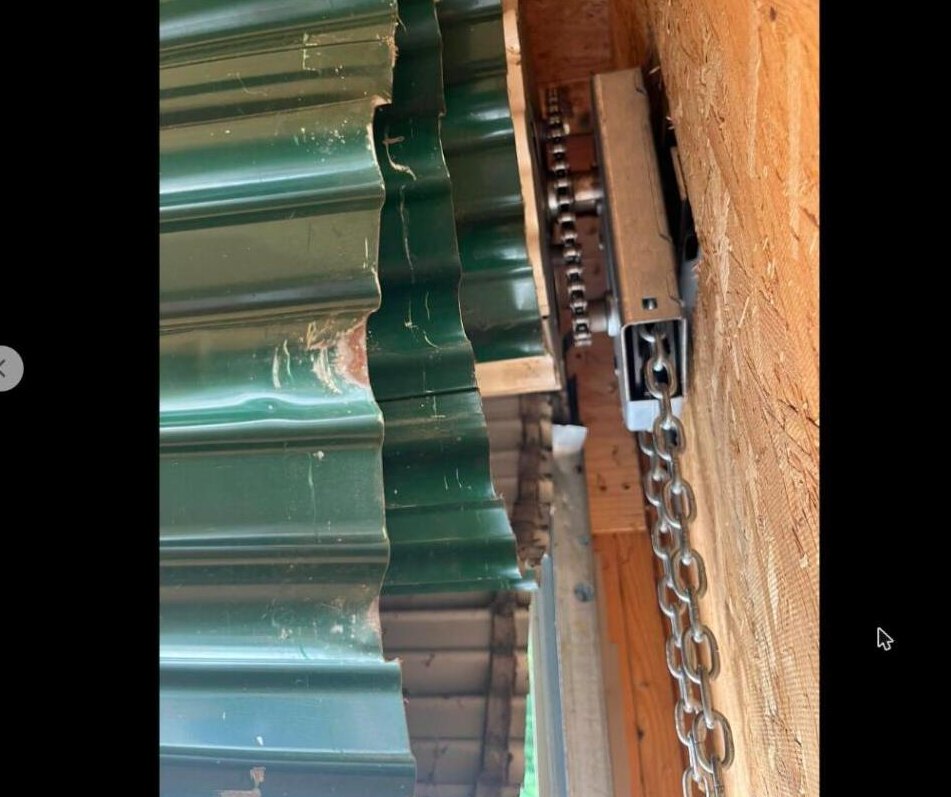 Damaged commercial green door before service